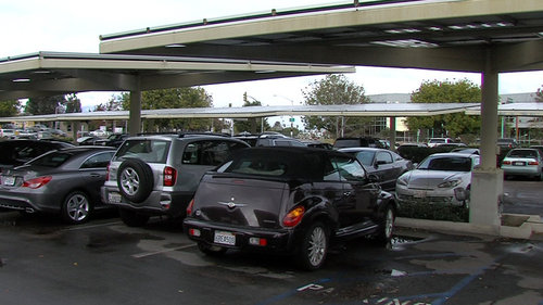 "Solar trees," which suspend solar panels over parking spaces in San Diego, collect electricity. Generating solar power like this is just one rung on a ladder the city will have to climb to reach 100 percent renewable energy by 2035. Clare Trageser /KPBS