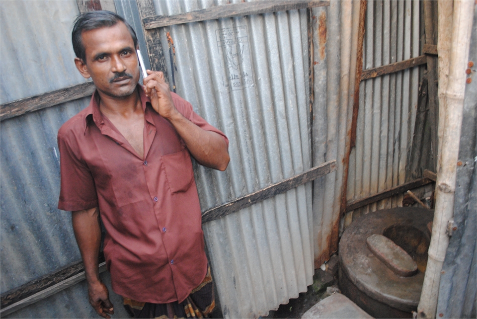 Abdul Malik, a 35-year-old rickshaw puller from Dhaka, shares a communal toilet with six families in the slums. Mobile phone usage has surged in recent years, while latrine usage has lagged Abdul Malik, a 35-year-old rickshaw puller from Dhaka, shares a communal toilet