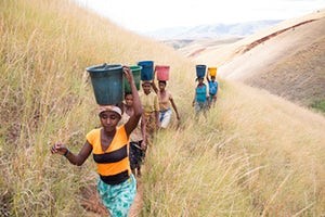 Women carrying bushels on their heads